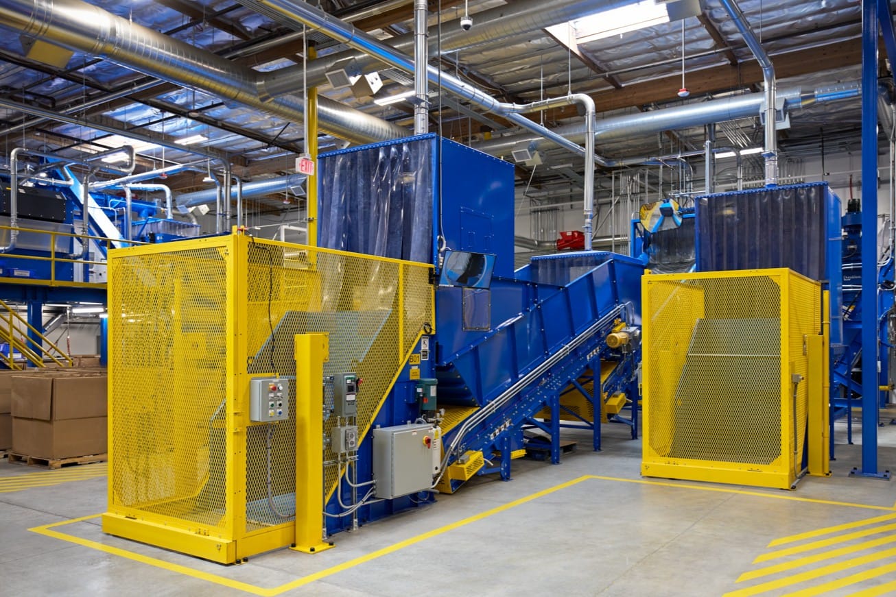 Cora, an Apple worker, in the Advanced Recovery Center surrounded by equipment for recycling.
