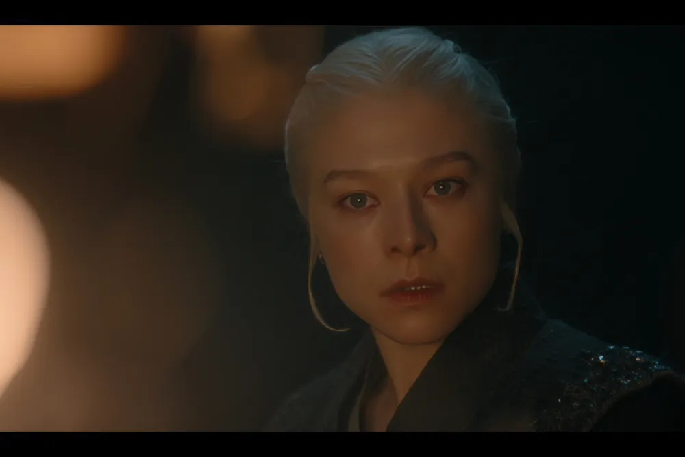 Close-up of a character's intense expression with a blurred background.