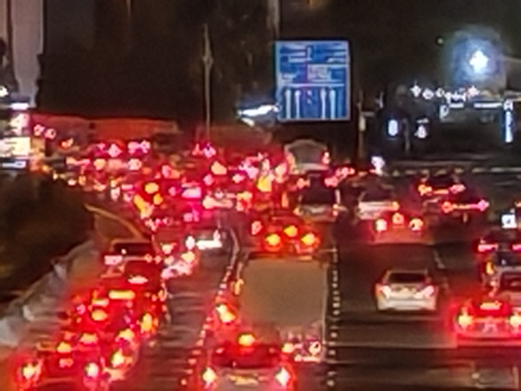 Honor 600 30x zoom night camera sample of stationary traffic showing heavy compression artefacts and red taillight glare