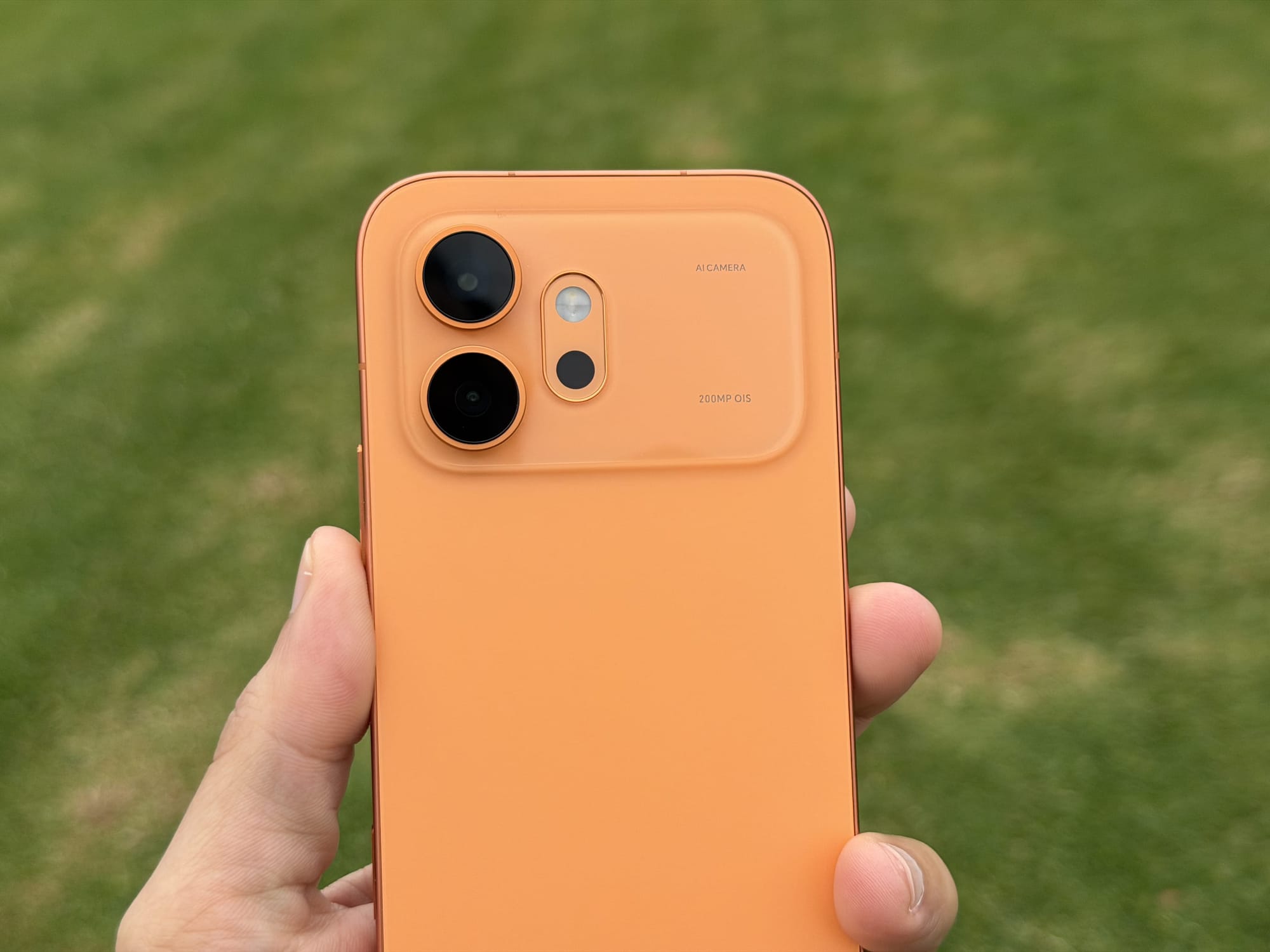 Close-up of the Honor 600 rear camera module with "AI Camera" and "200MP OIS" lettering on the orange housing