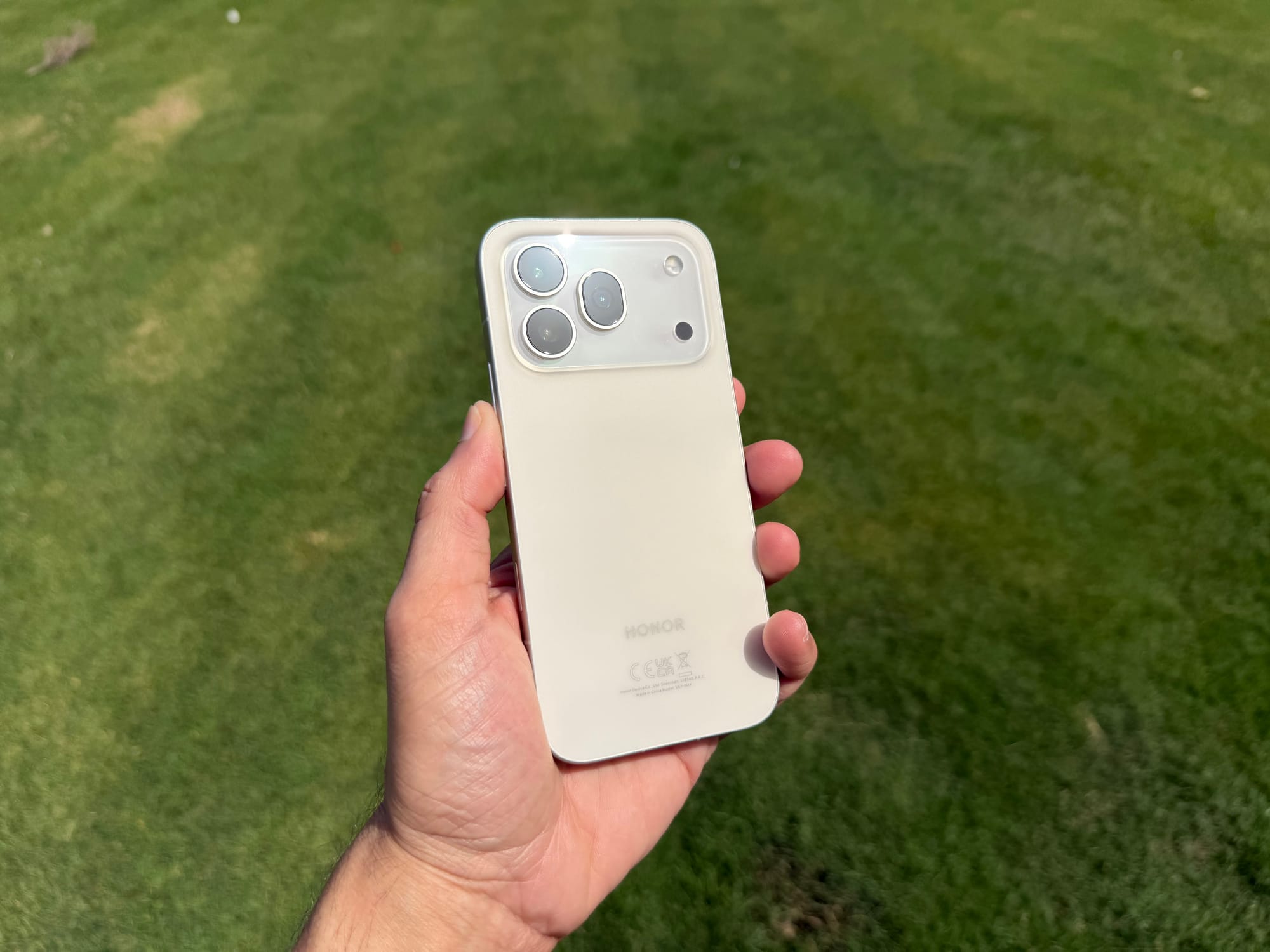 Honor 600 Pro smartphone held in hand, showcasing its back design and camera layout.