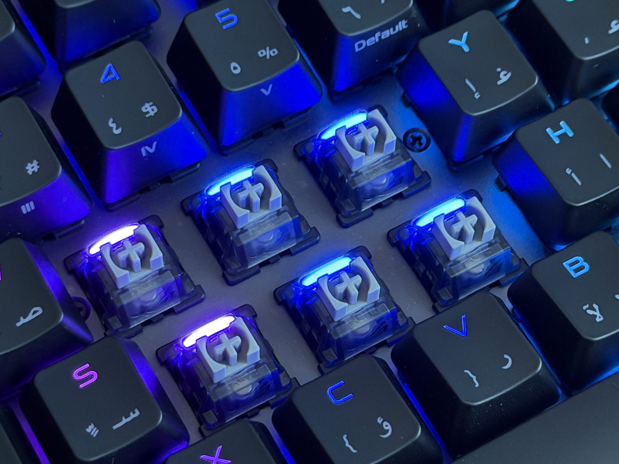 Close-up of illuminated mechanical switches under keycaps on ASUS ROG Falchion Ace.
