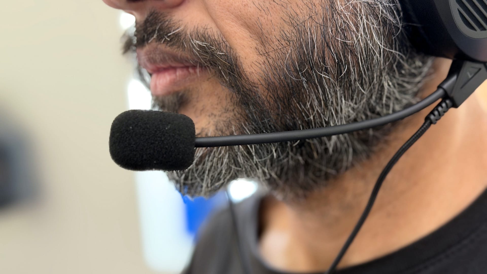 Man wearing the Asus ROG Kithara headset with the microphone positioned near his mouth.