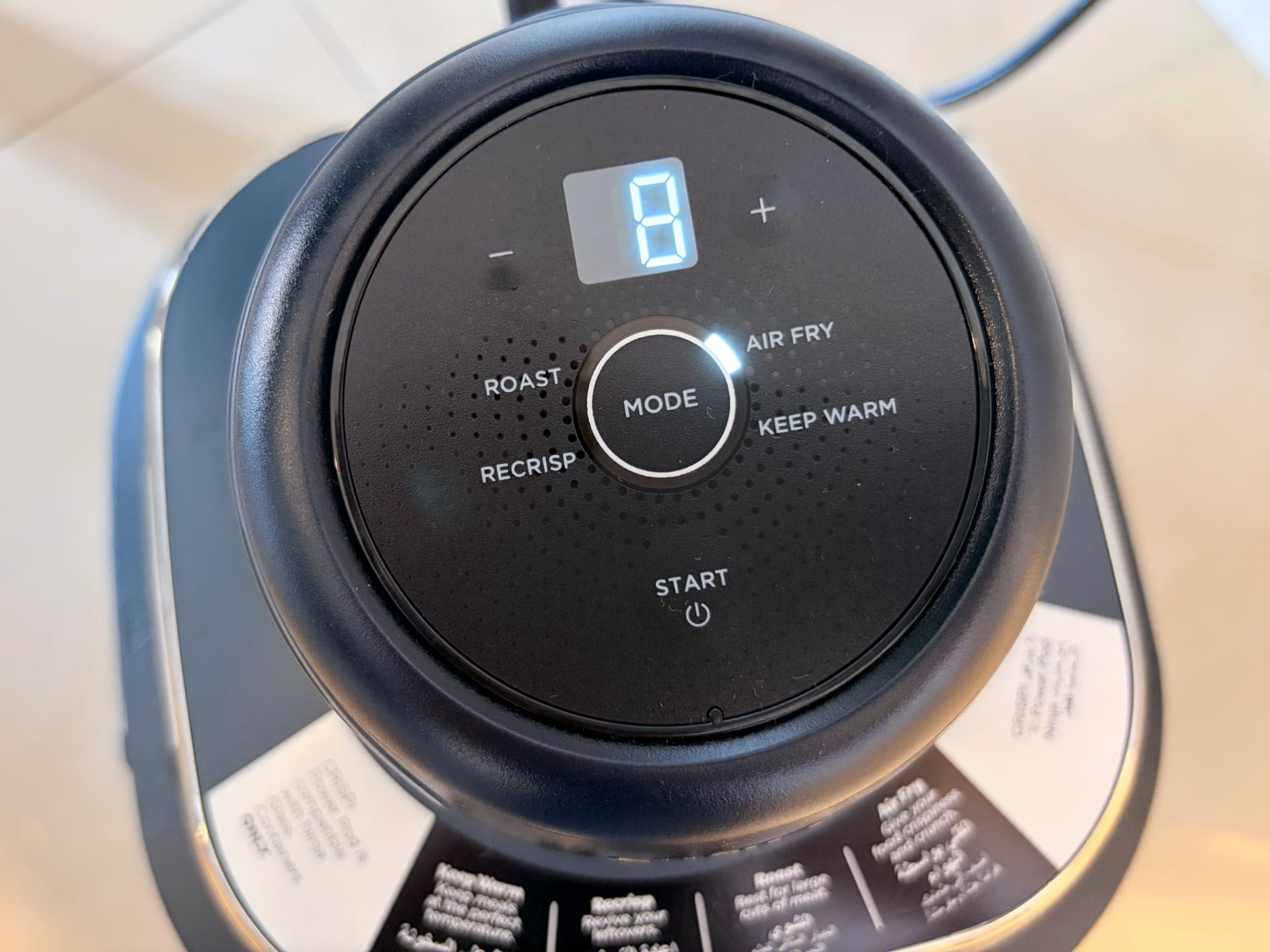 Ninja Crispi PowerPod showcasing its sleek design with control panel and cooking options