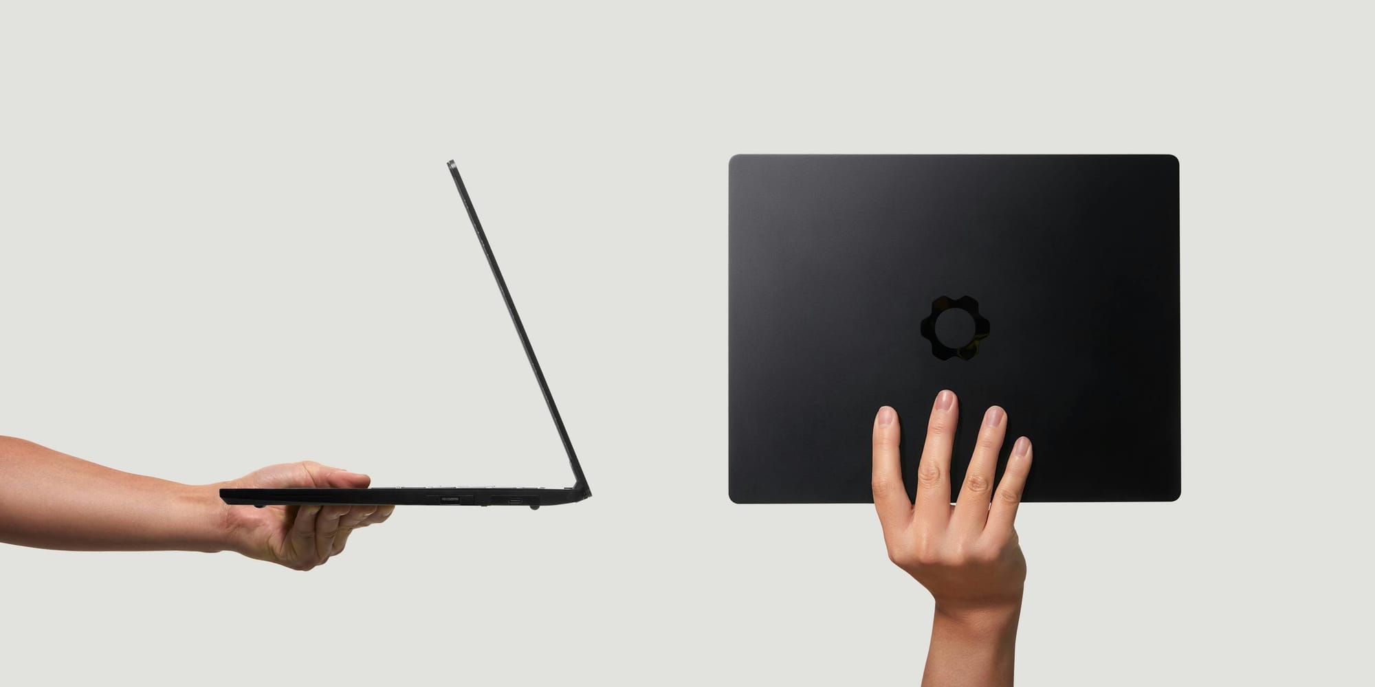 Framework laptop showcased with a thin profile, one held sideways and the other showing the back with logo.