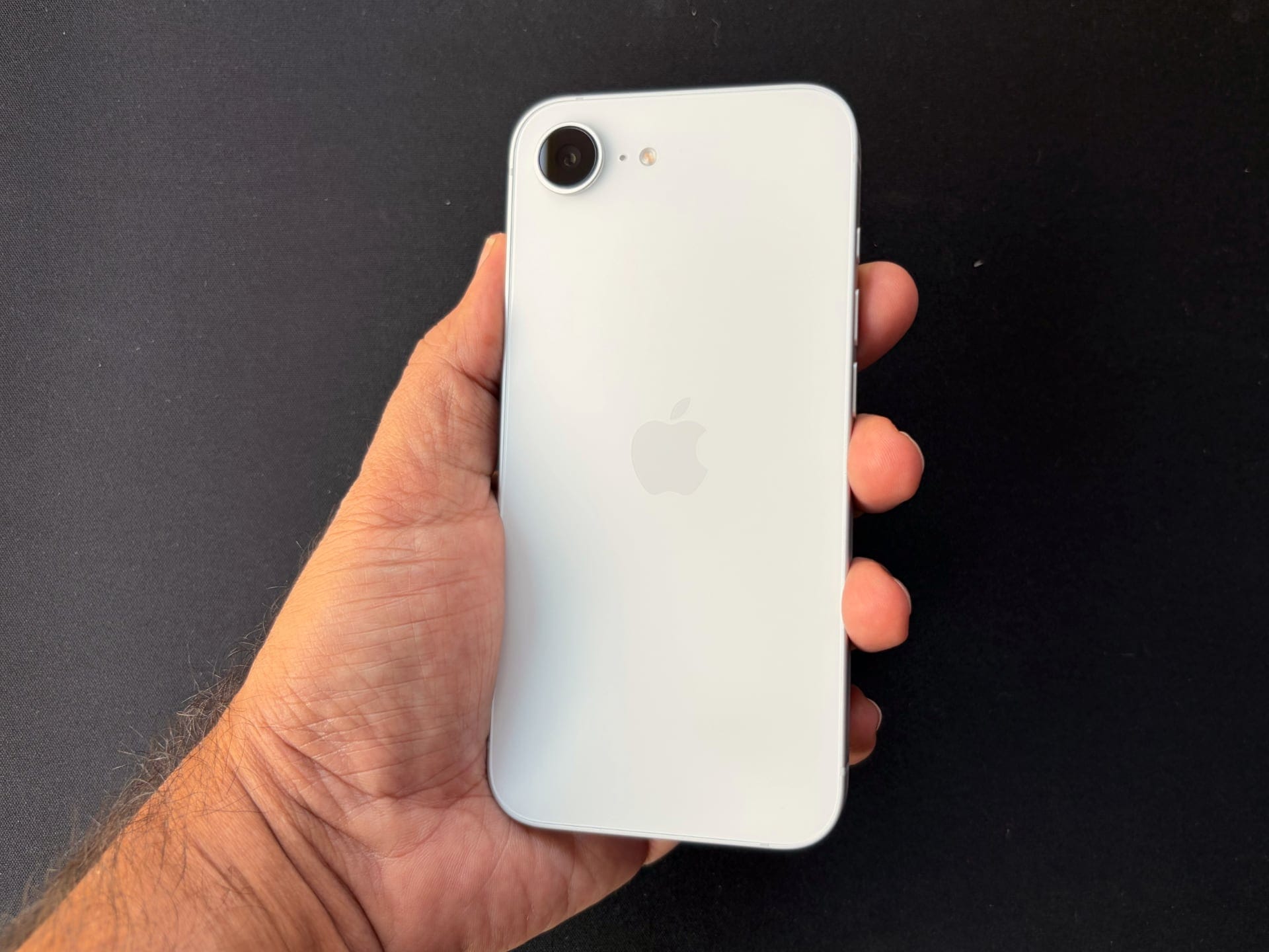 iPhone 17 held in hand, showing the back design.