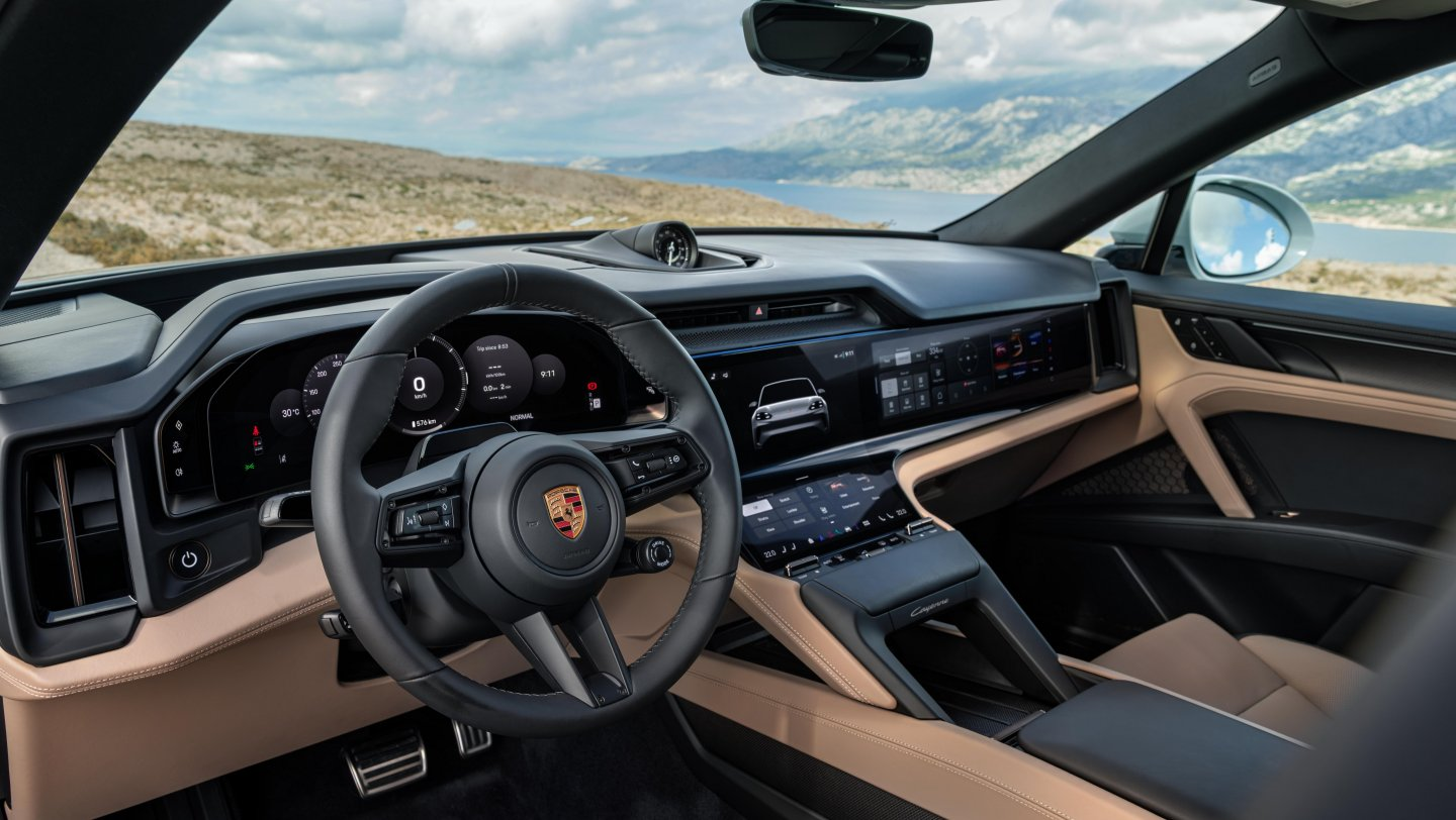 Interior of Porsche Cayenne Coupé Electric featuring a modern dashboard with dual screens and leather seats.