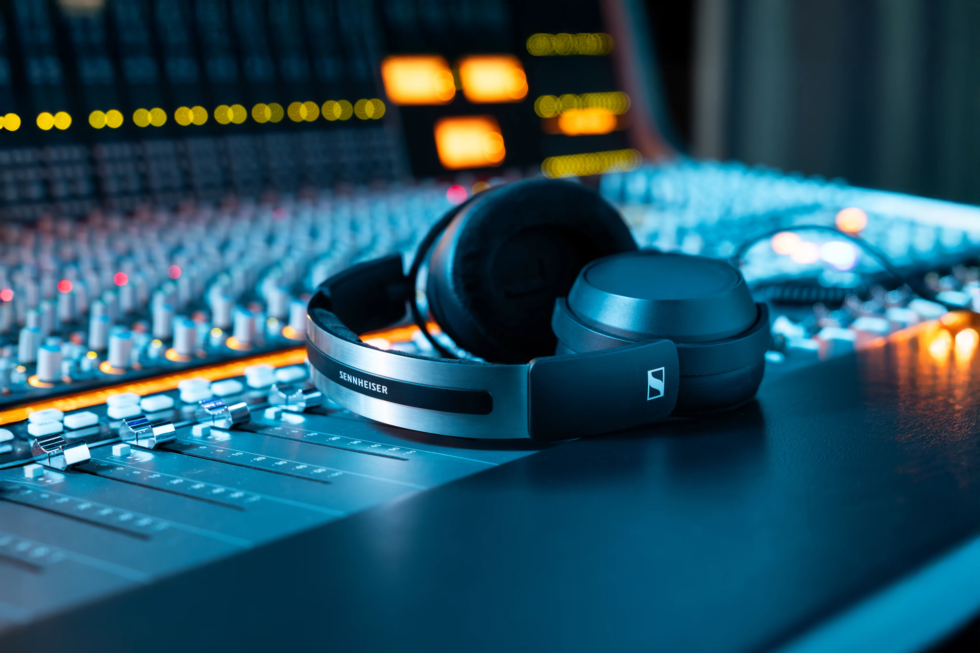 Sennheiser HD 480 PRO headphones on a mixer, highlighting a sleek design with black accents.
