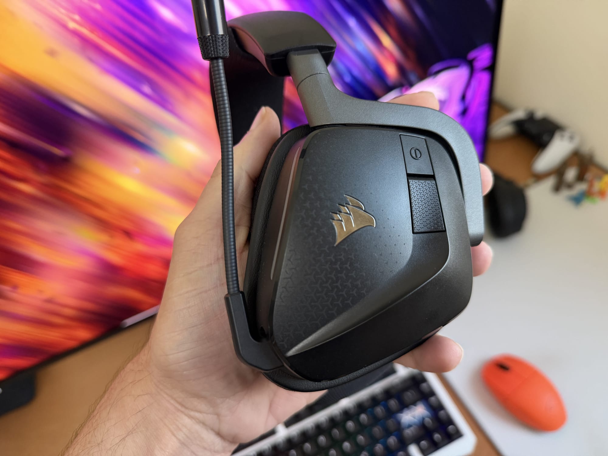 Corsair Void v2 MAX Wireless headset showing side view and buttons.