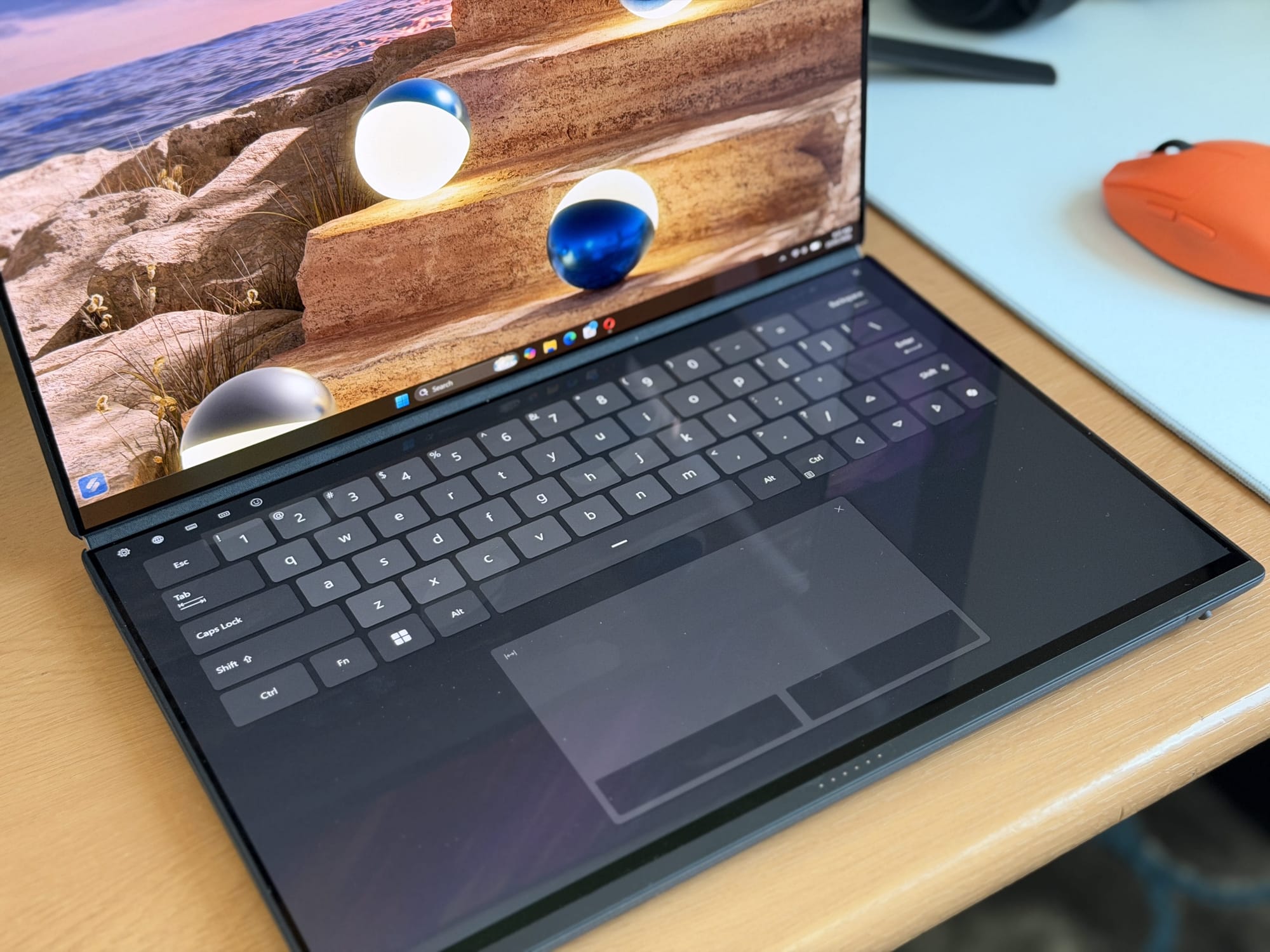 Close-up of Asus ZenBook Duo 2026 keyboard and secondary screen reflecting vibrant imagery.