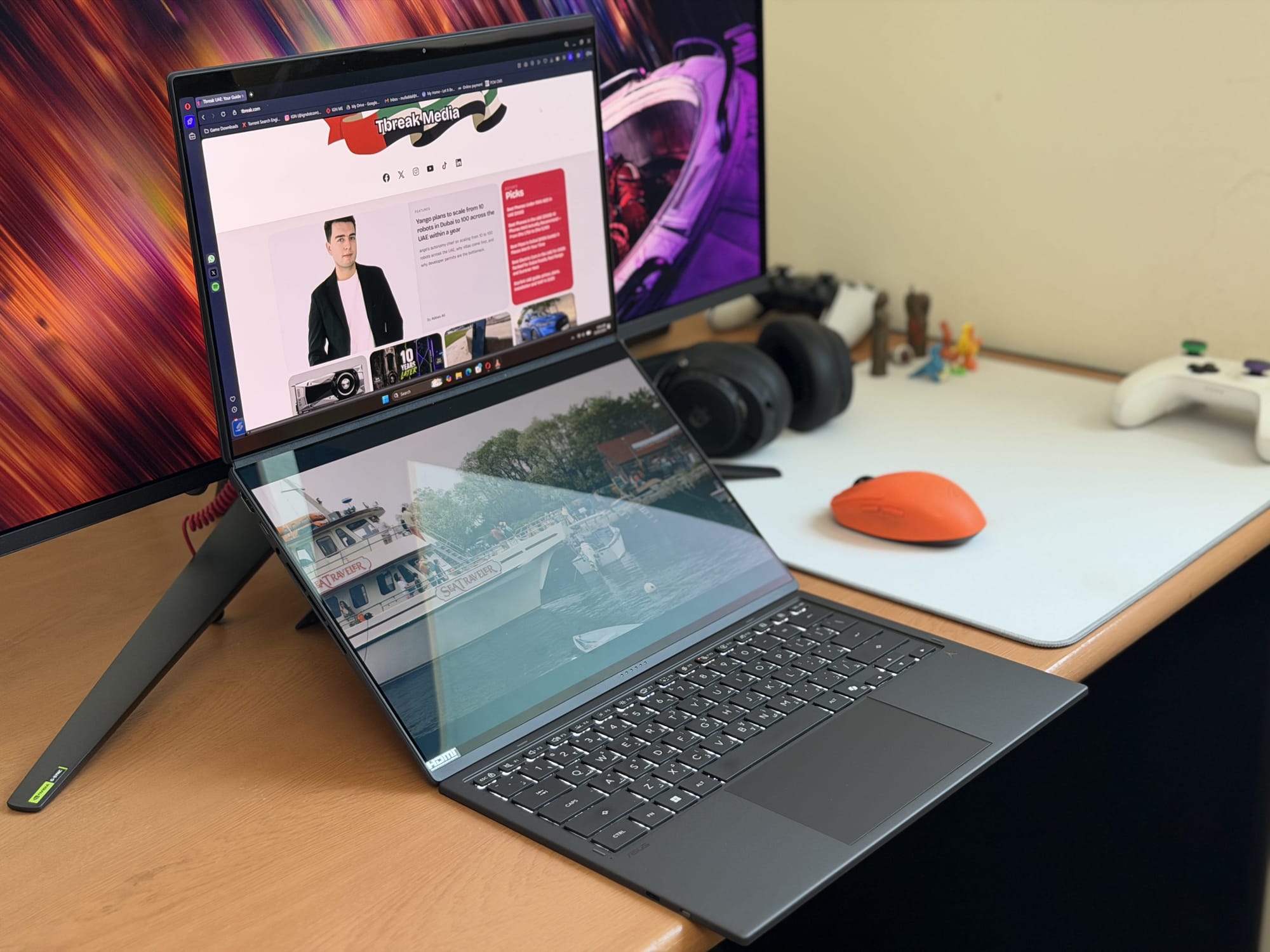 ASUS ZenBook Duo displaying dual screens with website and media browsing