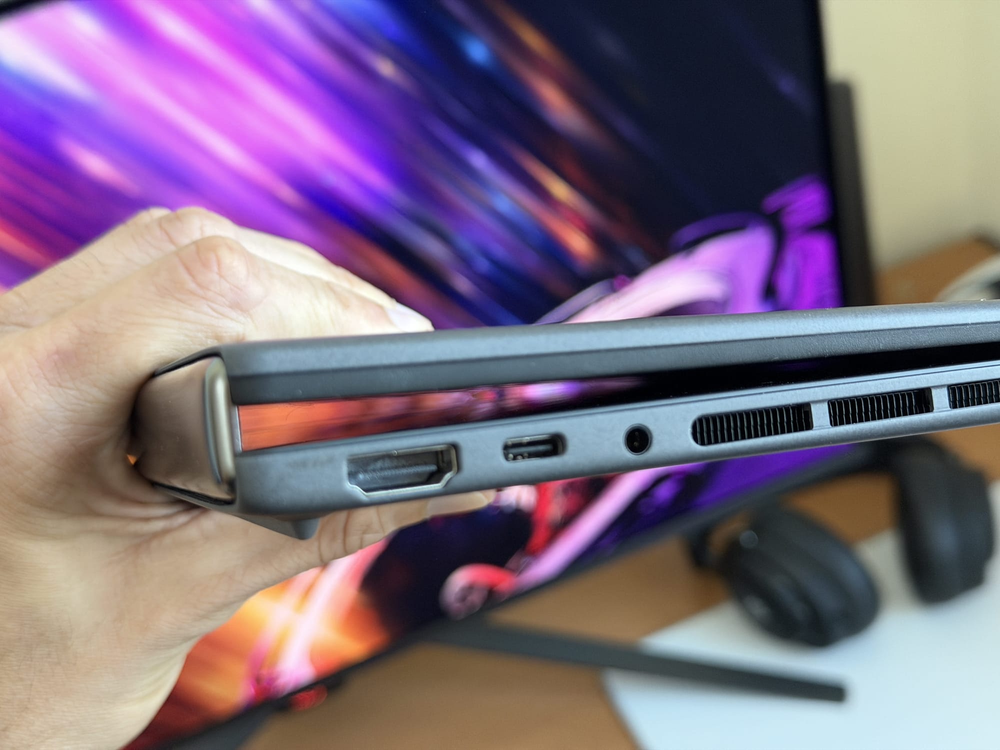 Side profile of ASUS ZenBook Duo with HDMI, USB-C, and audio ports visible