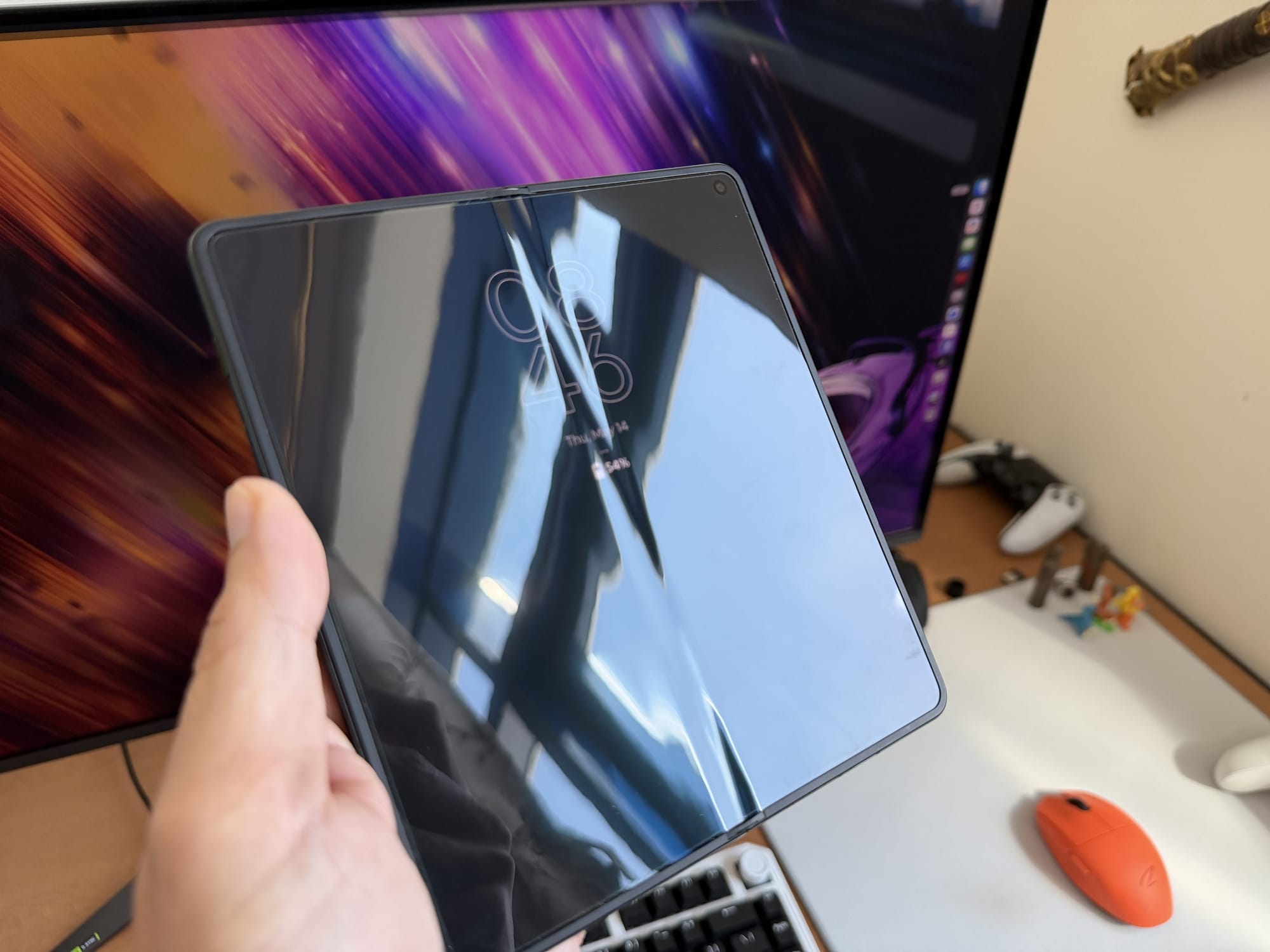Front view of the Motorola Razr Fold in a closed position, reflecting light.