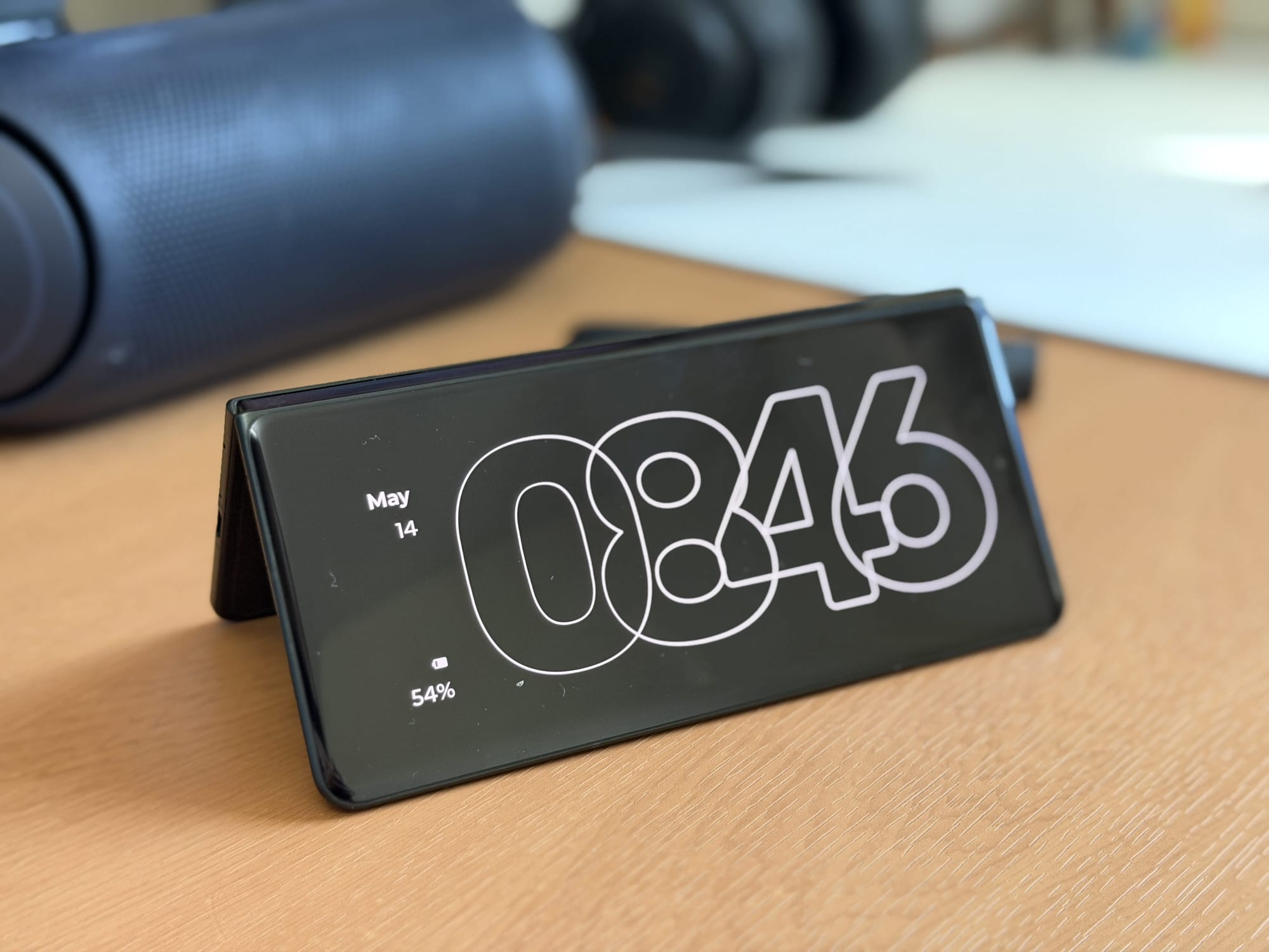 Motorola Razr Fold in a stand position, displaying the clock and battery status.