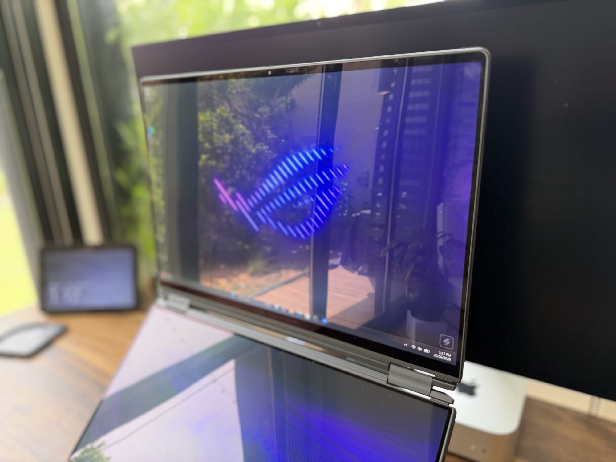 The two stacked 16-inch OLED panels displaying ROG wallpaper