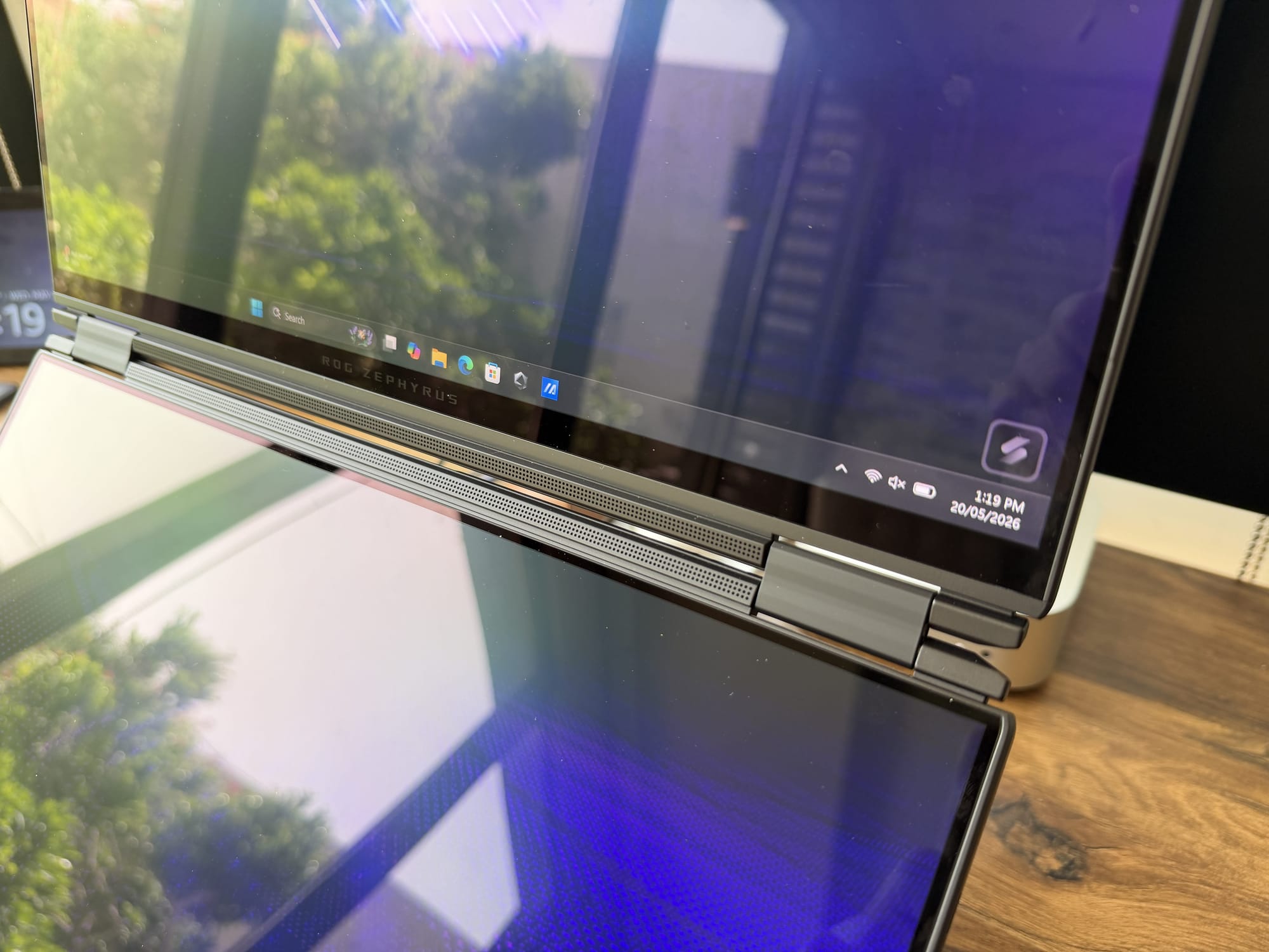 The Zephyrus Duo open on a desk with the upper 16-inch OLED panel active
