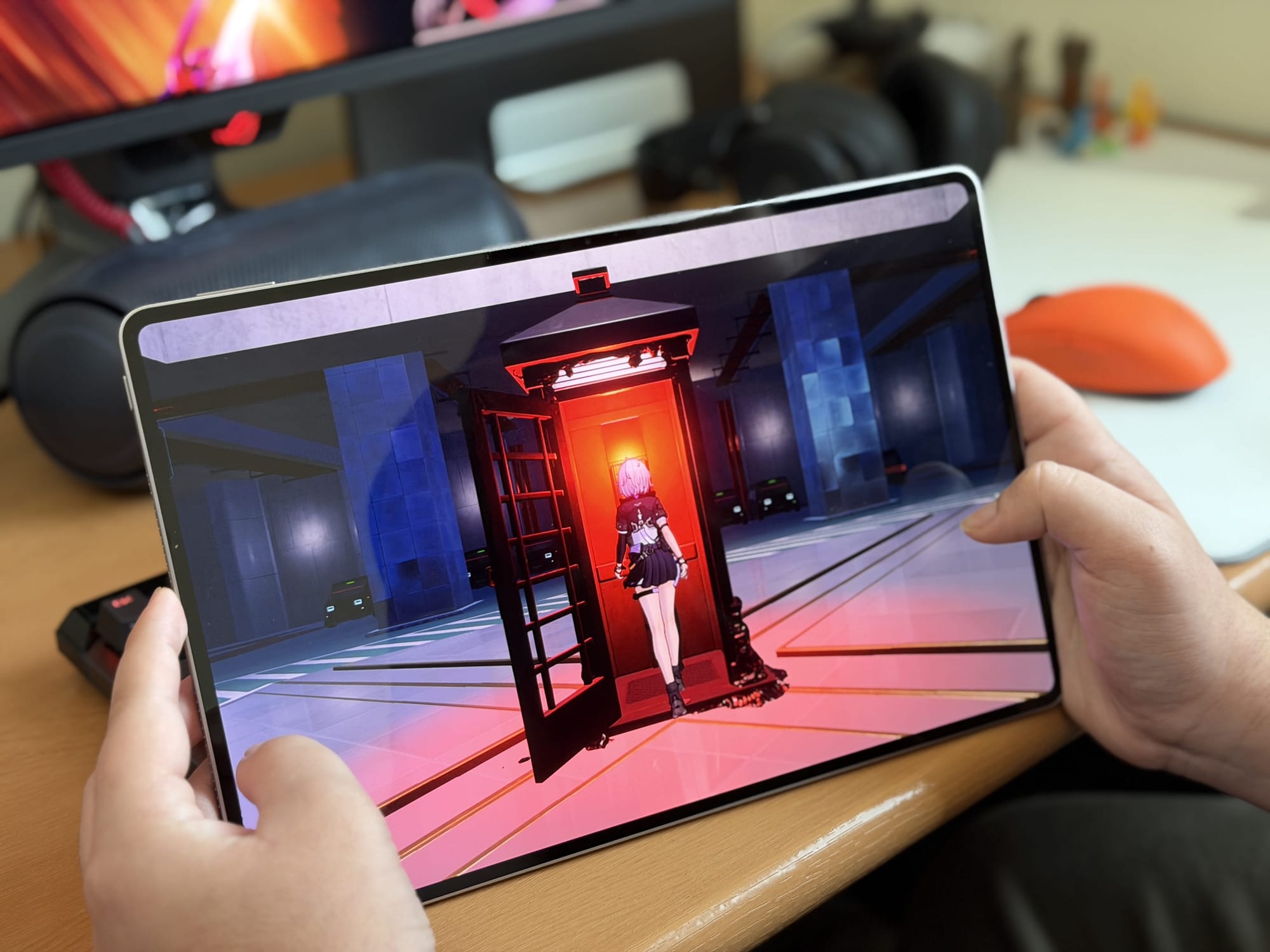 User playing a game on Honor MagicPad 4, touchscreen interaction shown.