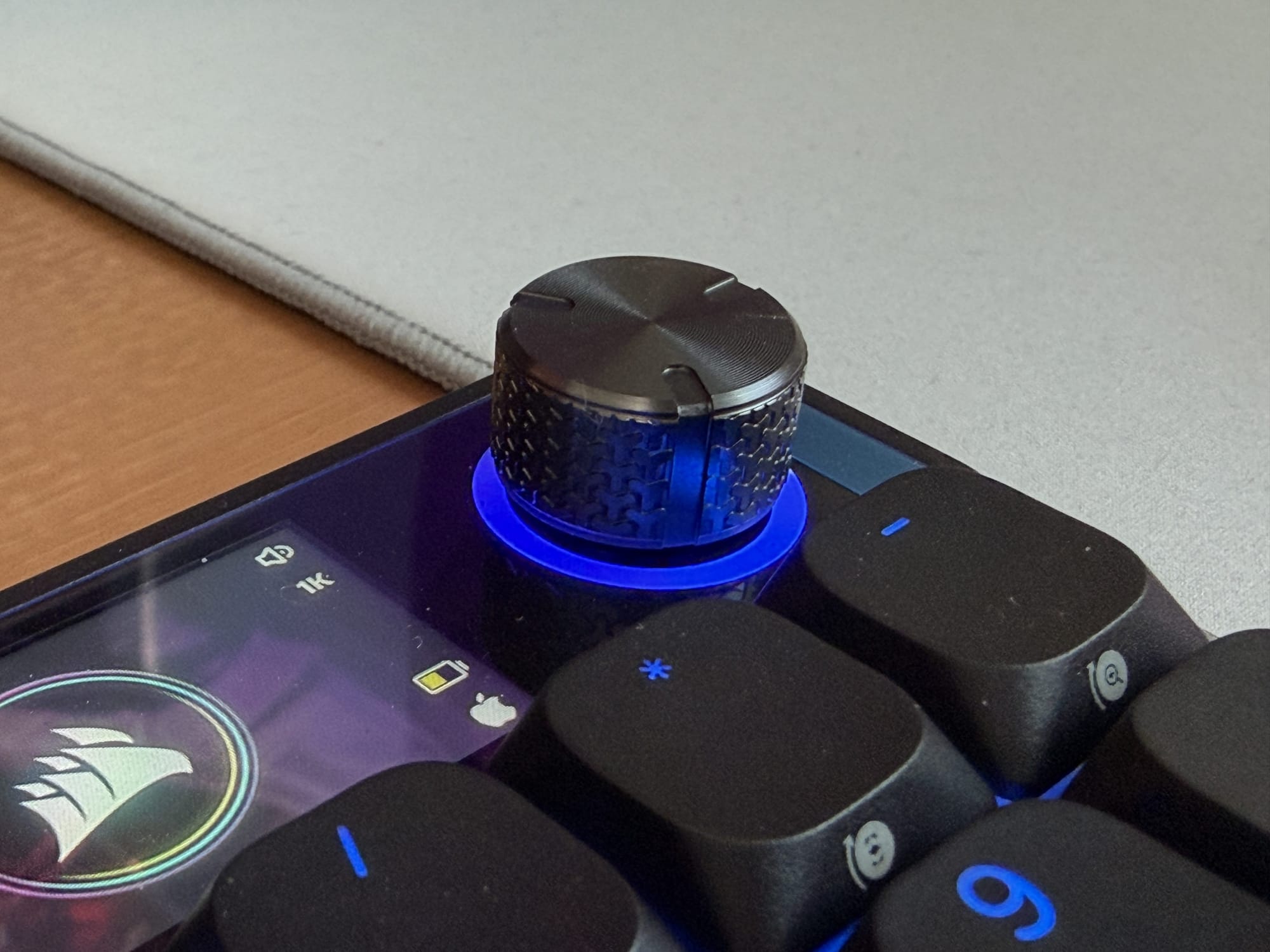 Close-up of the volume knob on the Corsair Vanguard Air 99 with blue LED lighting.