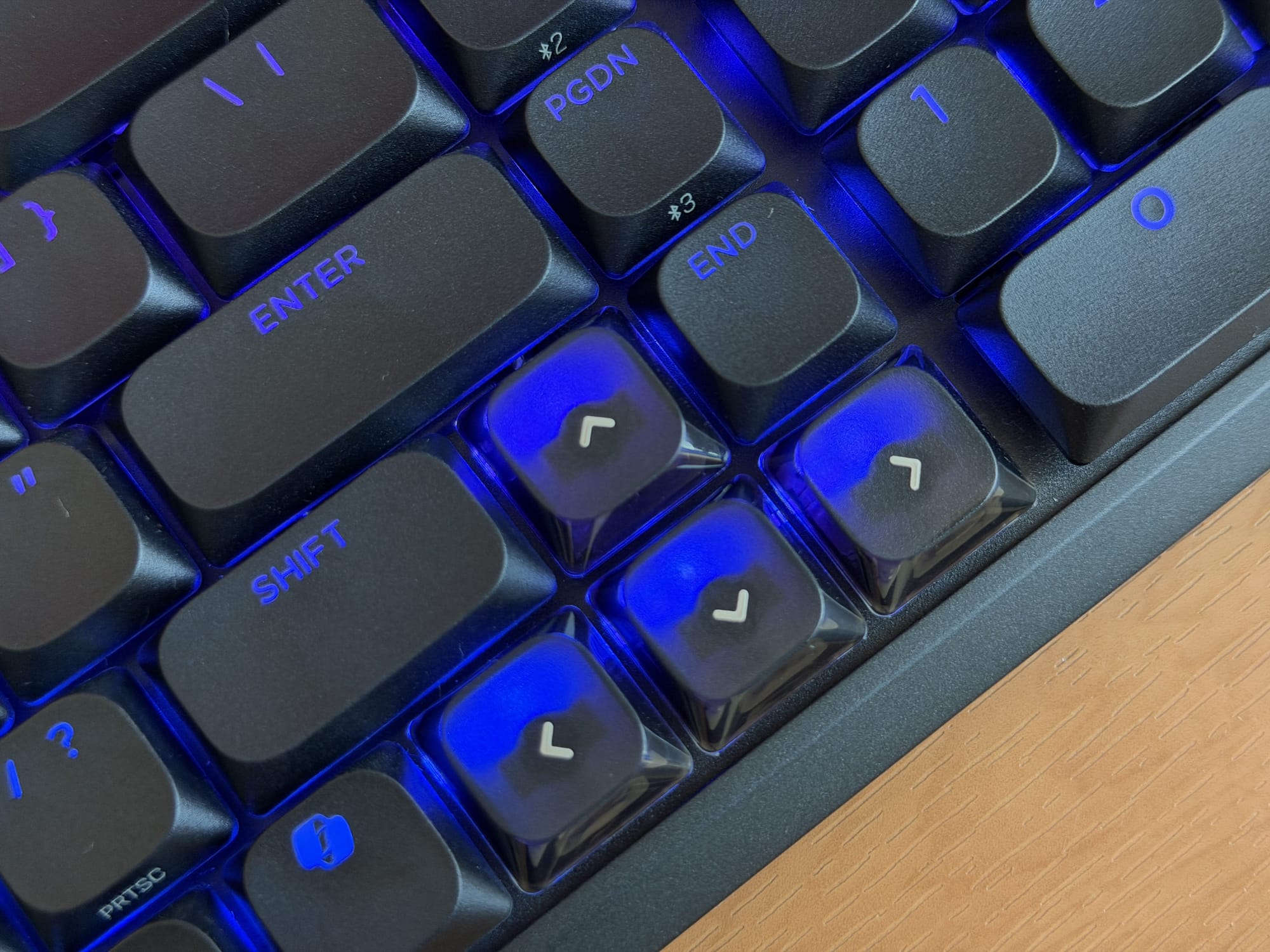 Close-up of Corsair Vanguard Air 99 keyboard keys with blue LED lighting highlighting shift and enter keys.