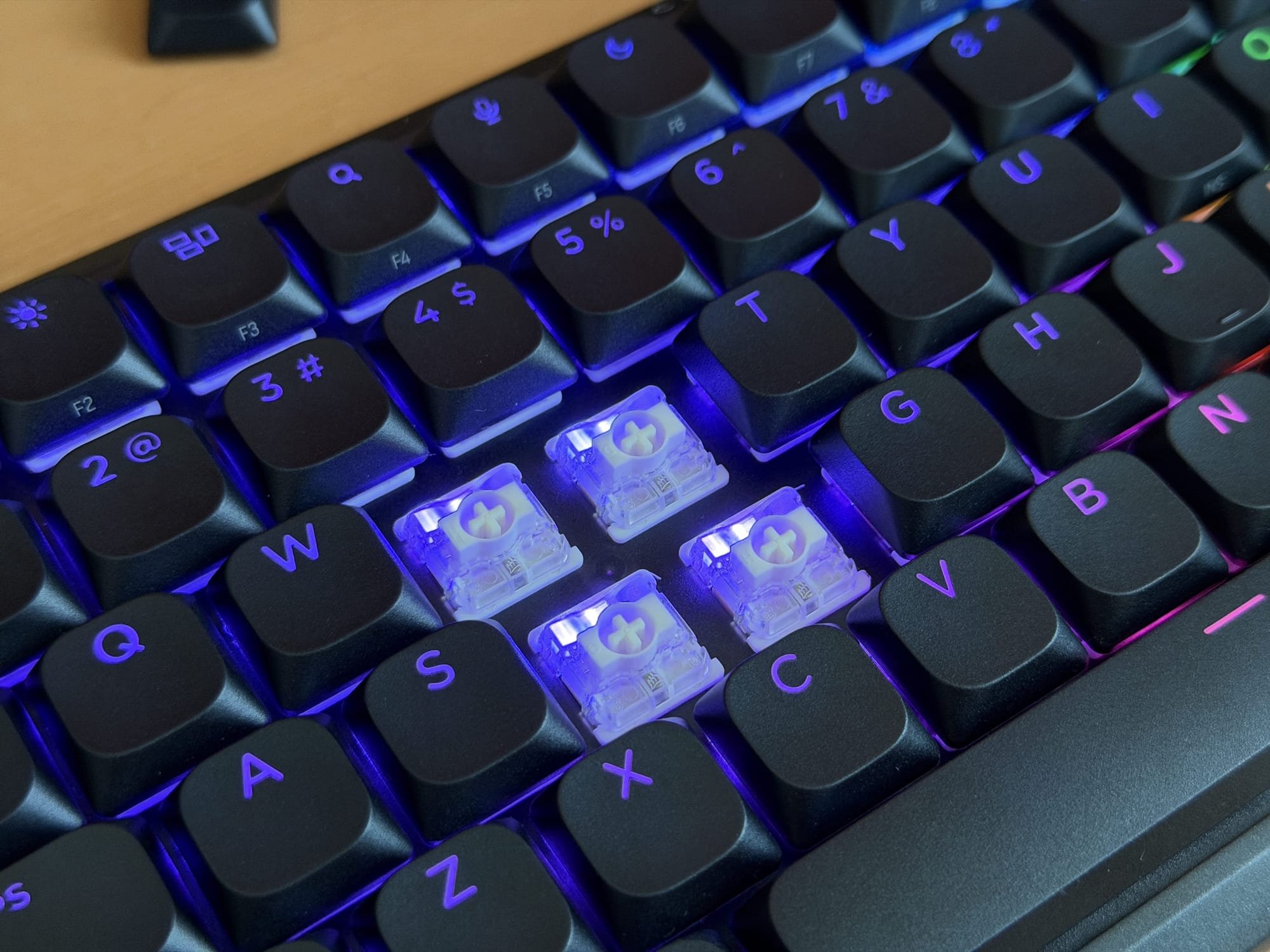 Corsair Vanguard Air 99 keyboard with transparent switches and blue lighting on keys.