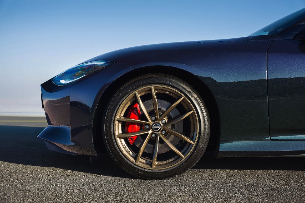Close-up of the Nissan Z Heritage Edition's wheel with bronze alloy and red brake calipers.