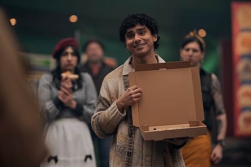 A character holding an empty pizza box, surrounded by curious onlookers.