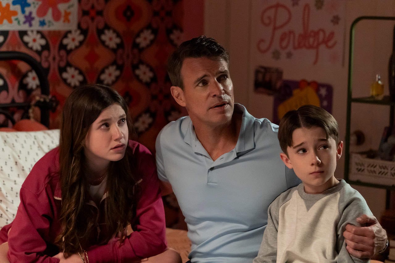 Scott Foley with two children sitting together in a cozy room.