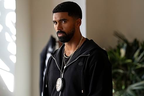 Major character from Nemesis standing in an office, wearing a black hoodie and a badge.