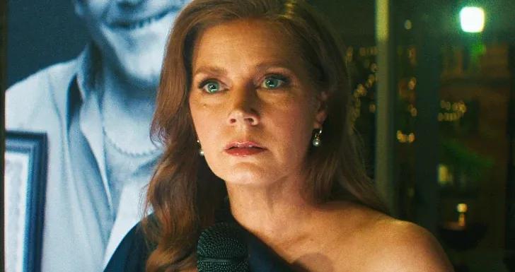 A woman with a microphone looks anxious during a pivotal scene.