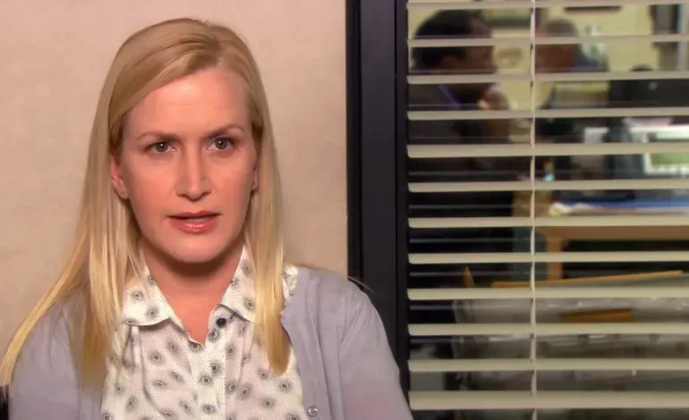 Angela Martin sitting in an office, looking serious, with office background blurred.