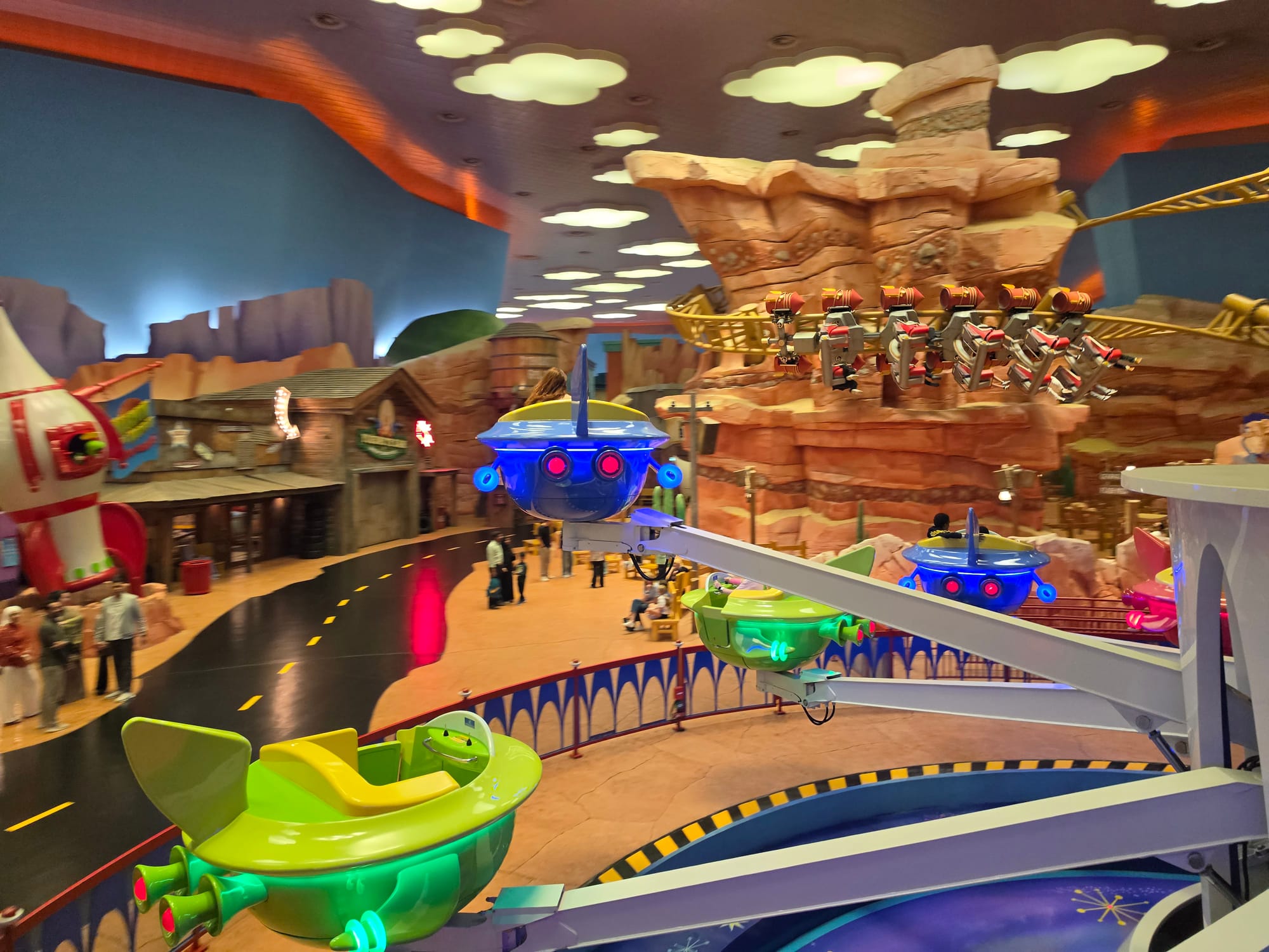 Colorful amusement park ride with animated characters and rock formations