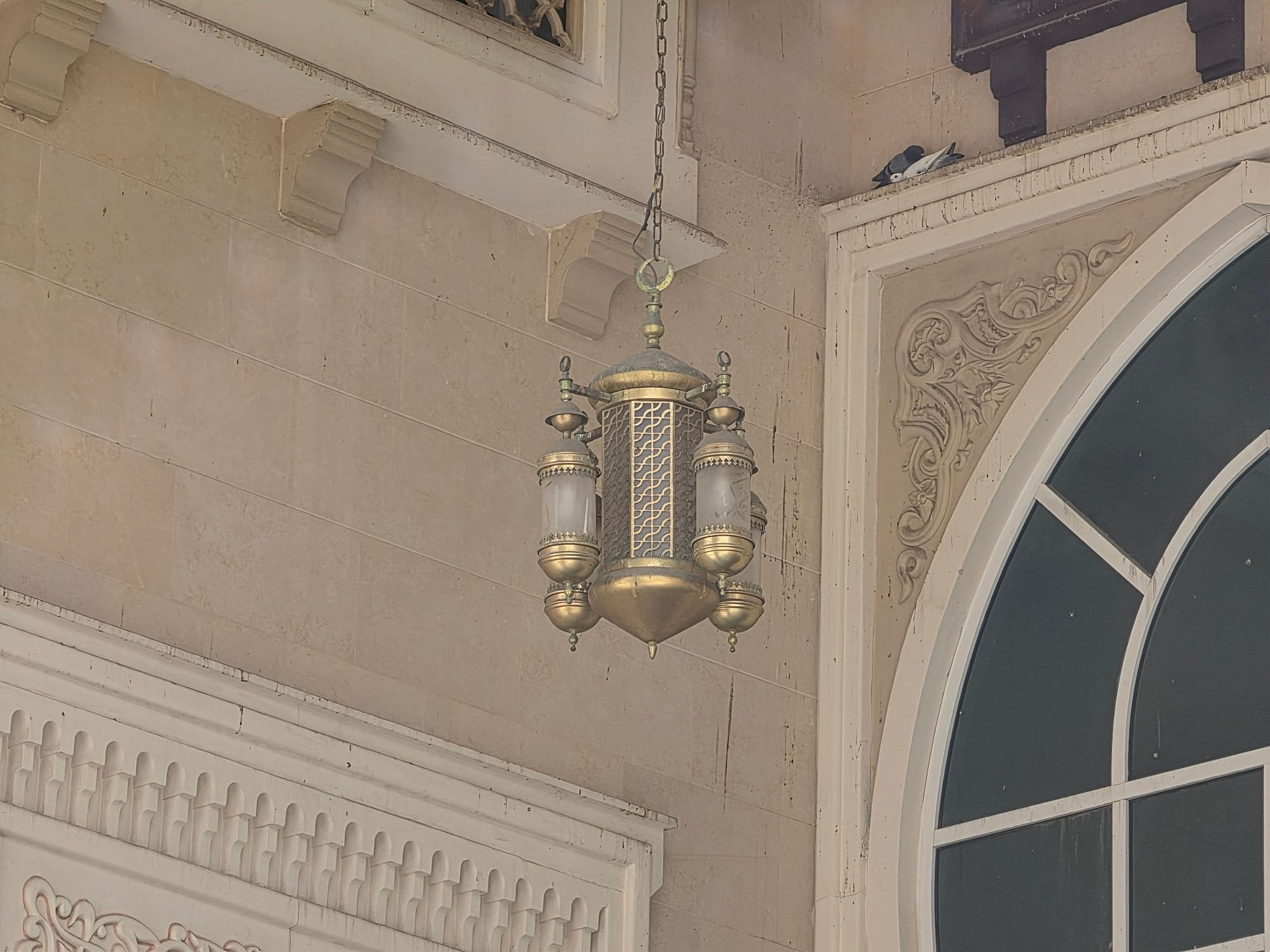 Hanging lantern inside the mosque, showing ornate design and craftsmanship.