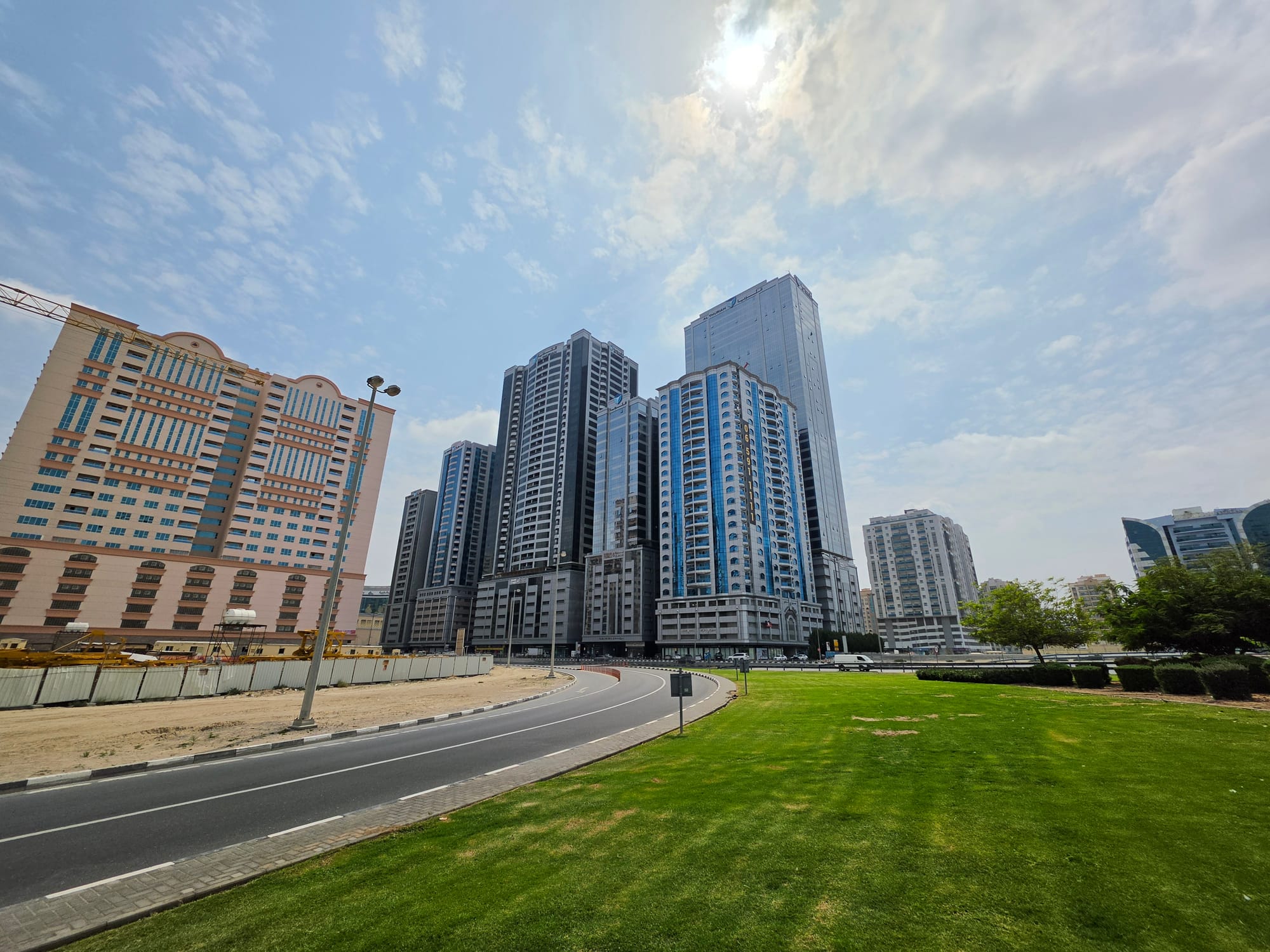 Urban skyline featuring modern buildings under a cloudy sky