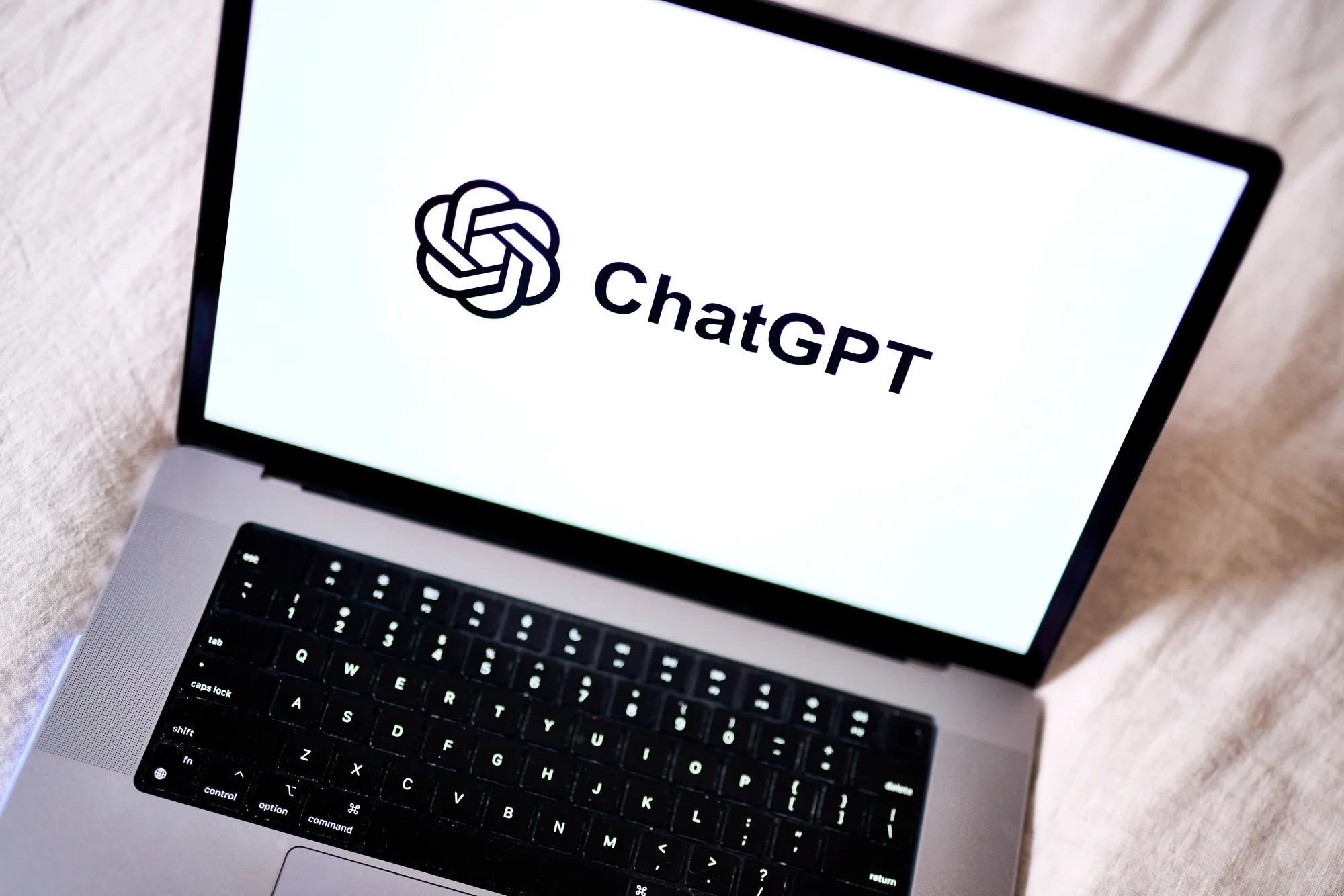 ChatGPT logo on a laptop screen with the new Apple Messages plugin active