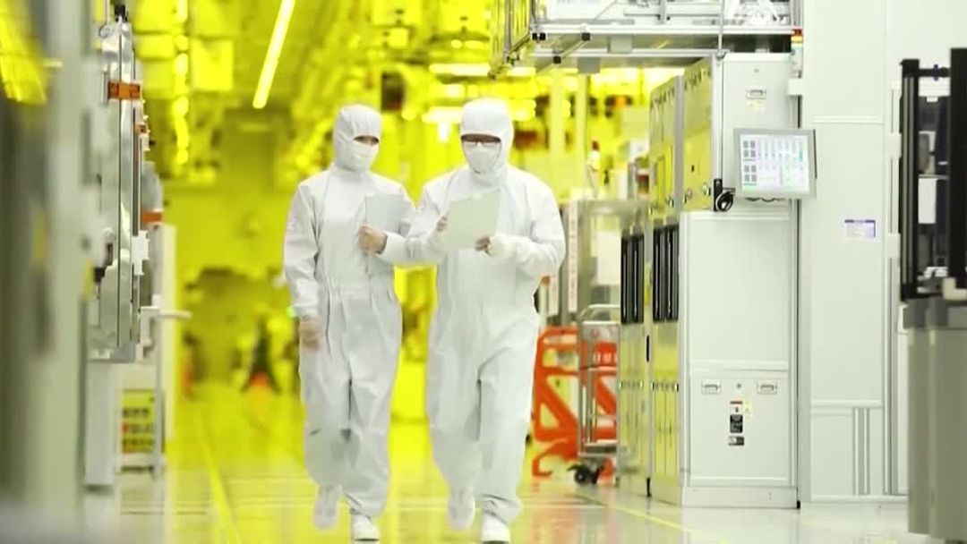 Samsung semiconductor production facility with workers in cleanroom suits