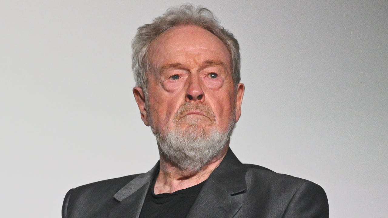 Ridley Scott in a dark jacket portrait, speaking about the Alien franchise sequel