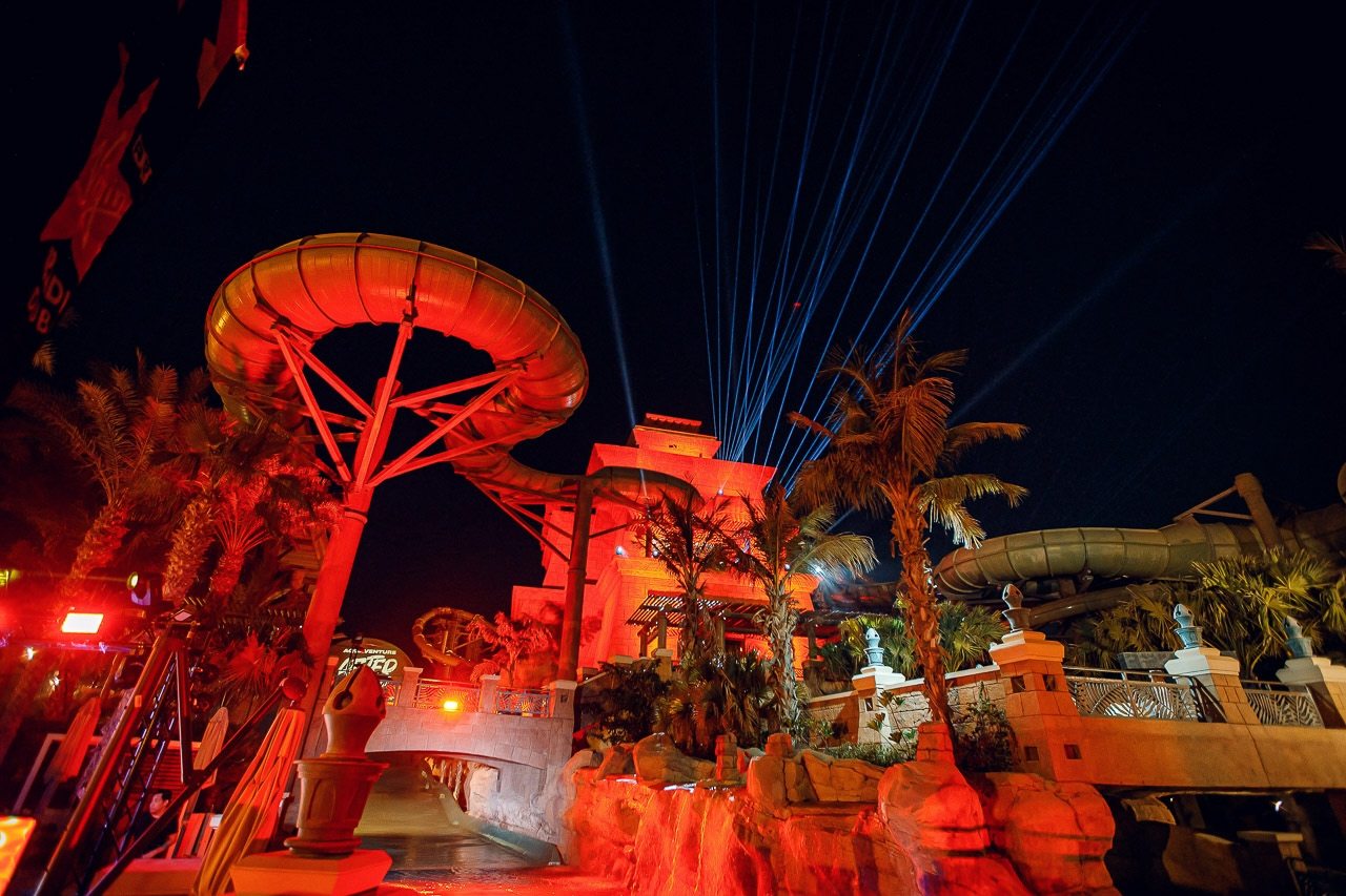 Aquaventure World at night during Aquaventure After Dark, red-lit slides and blue lasers at Atlantis The Palm