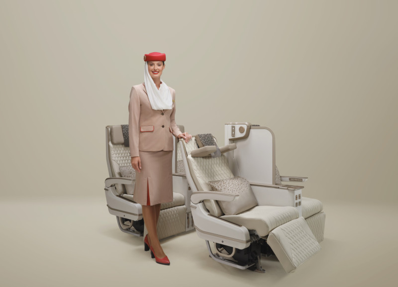 Emirates Premium Economy seat with full-height privacy screen and cabin crew