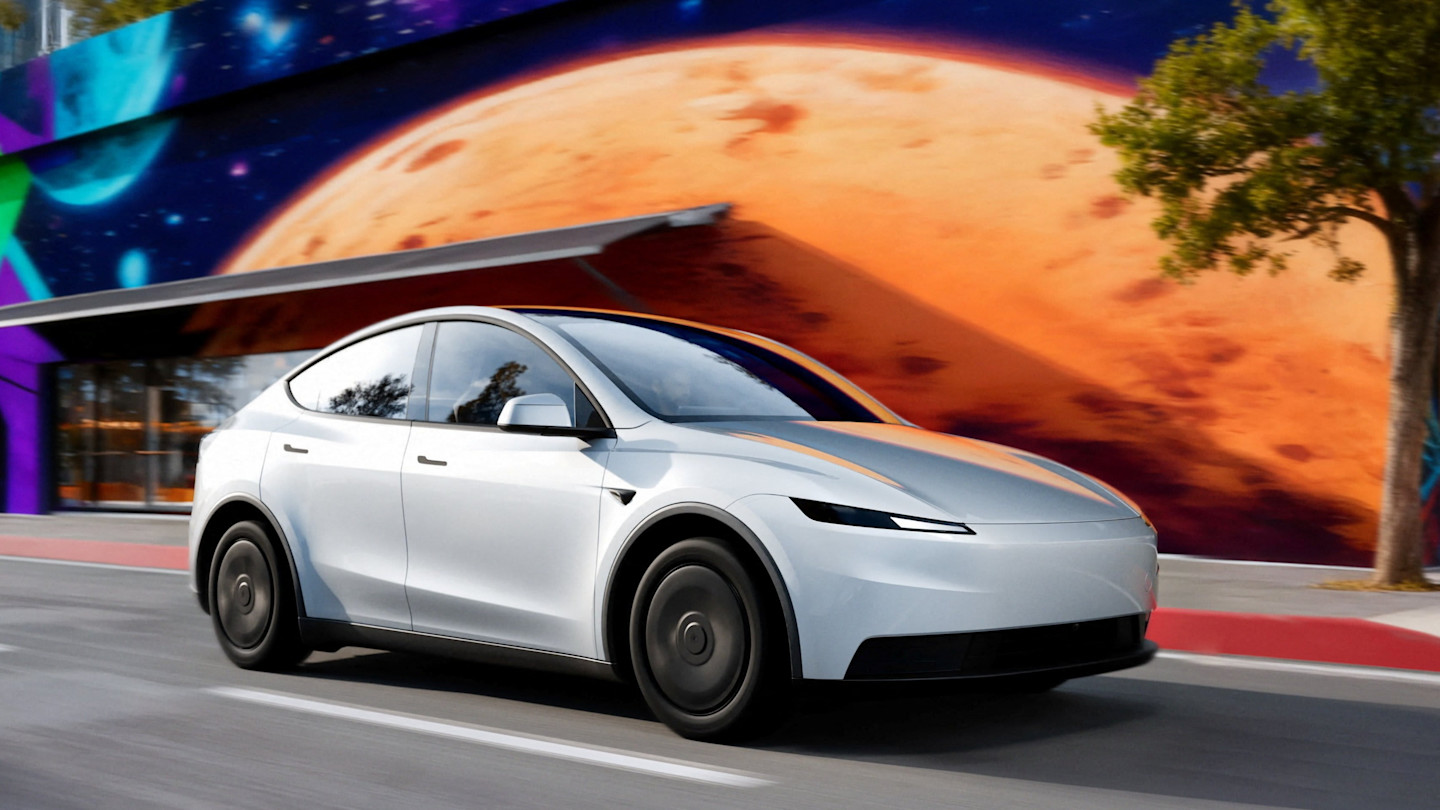 White Tesla electric vehicle driving through a city street