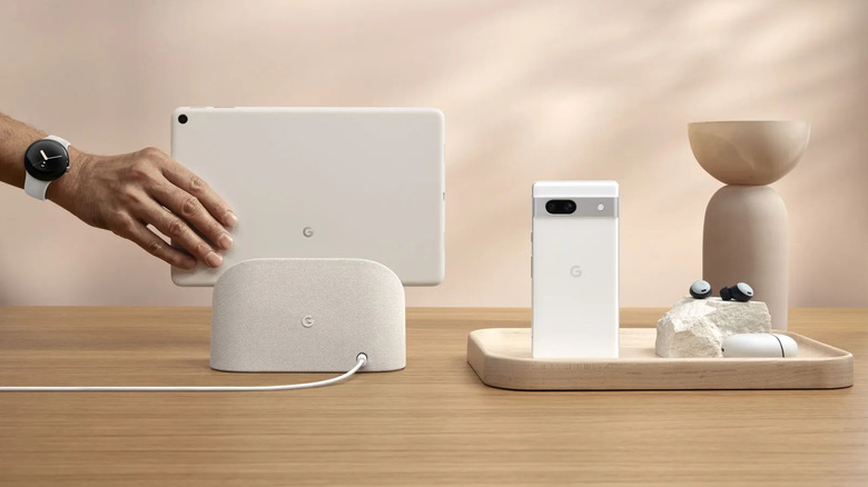 Google Pixel Tablet on charging dock beside Pixel devices
