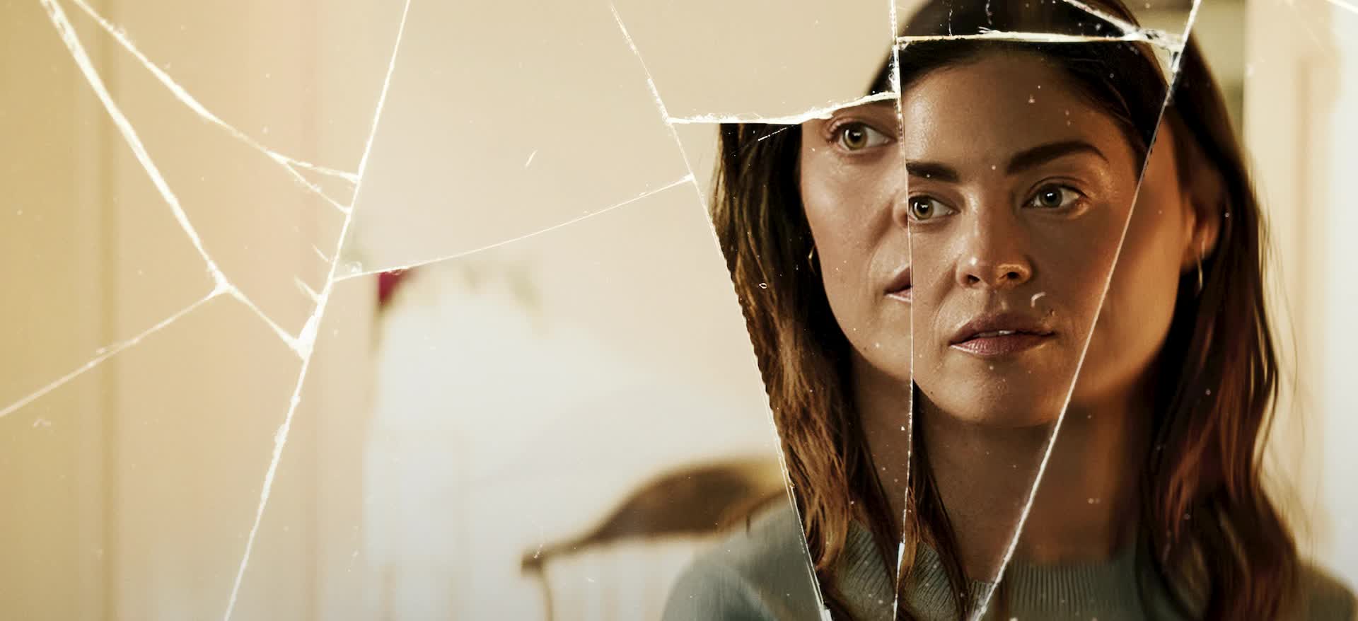 The Secret Woman Netflix thriller woman seen through shattered glass