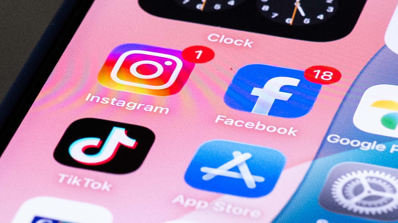 Meta and TikTok logos on phone screens